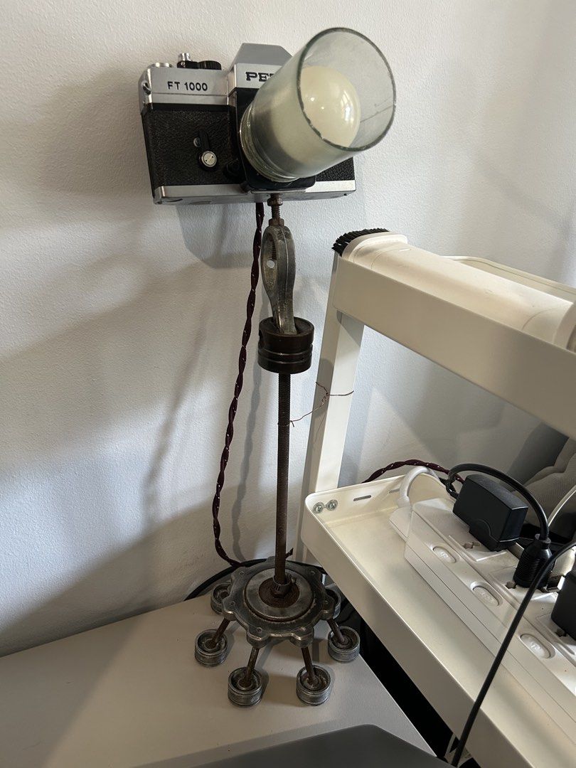Pentax FT 1000 Camera Lamp - Unique Vintage Decor (Category: Other Photography Accessories) located in Manila. Submitted by garagesale.fire (Listing ID 1463145161, Image 2). Description: - Cool desk lamp crafted from a Pentax FT 1000 camera. - Features a light bulb fitted into the lens with a glass cover. - Vintage, industrial-style stand with a weighted base for stability. - Adds a unique, eye-catching touch to any room. - Fully functional and w