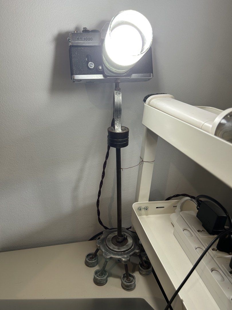 Pentax FT 1000 Camera Lamp - Unique Vintage Decor (Category: Other Photography Accessories) located in Manila. Submitted by garagesale.fire (Listing ID 1463145161, Image 1). Description: - Cool desk lamp crafted from a Pentax FT 1000 camera. - Features a light bulb fitted into the lens with a glass cover. - Vintage, industrial-style stand with a weighted base for stability. - Adds a unique, eye-catching touch to any room. - Fully functional and w