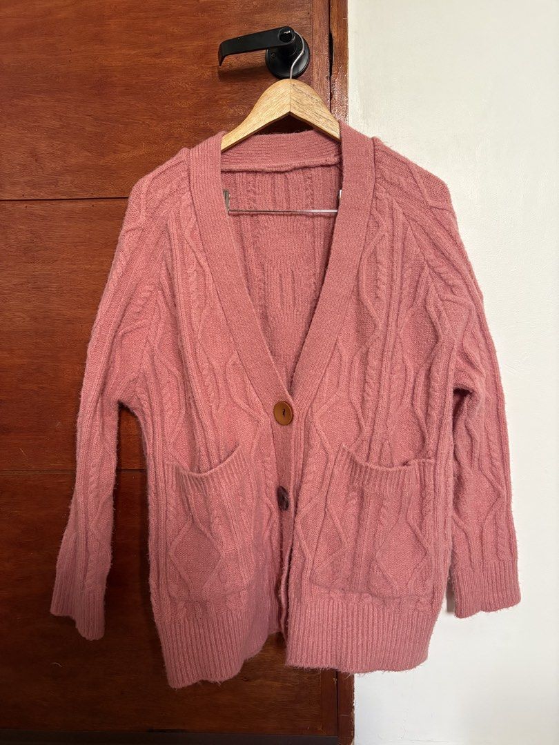 Pink Cable Knit Button Up Cardigan with Pockets (Category: Coats, Jackets and Outerwear) located in Taguig. Submitted by cftbncs (Listing ID 1463176220, Image 1). Description: - Cozy pink cable knit cardigan - V-neck design - Button-up front closure - Two convenient front pockets - Soft and warm material, ideal for layering - very heavy - Perfect for cooler weather and versatile styling.