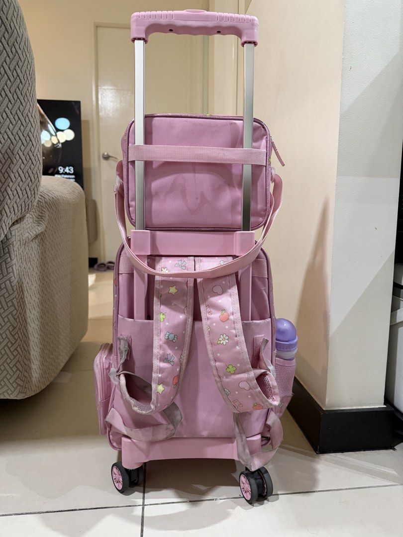 Pink Sanrio Characters Trolley bag (Category: Backpacks) located in Makati City. Submitted by dpgaquino_ (Listing ID 1463263815, Image 2). Description: Includes a matching lunch bag, and rain cover. Bought in SM store around P 3,800 Preloved but still in good condition just needs thorough cleaning. No defects on wheels still working fine. Has lights .