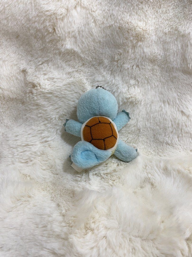 Pokemon Squirtle Plush Charm Keychain (Category: Character Goods) located in Kalibo. Submitted by ollie_stuffshop (Listing ID 1463172077, Image 2). Description: Before you send your inquiries: ❗️Last Price is already posted ❗️Manage your expectations, WYSIWYG ❗️May need washing ❗️Dropoff is every Wednesday & Sunday - Adorable Squirtle plush toy - Features a keychain attachment - Classic blue body with iconic brown shell - Ideal for any Pokemon en