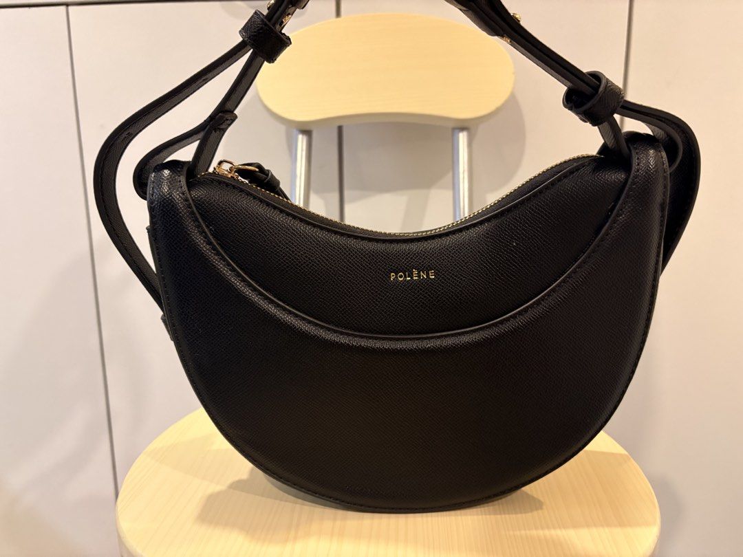 POLENE Black Crescent Shoulder Bag (Category: Luxury Bags & Wallets) located in Manila. Submitted by jonahgmzn (Listing ID 1463226936, Image 1). Description: - Black Polene bag - Stylish crescent shape - Secure zip closure - Convenient front pocket detail - Adjustable strap for comfort - Elegant gold hardware - Ideal for everyday use - Fits all your essentials.
