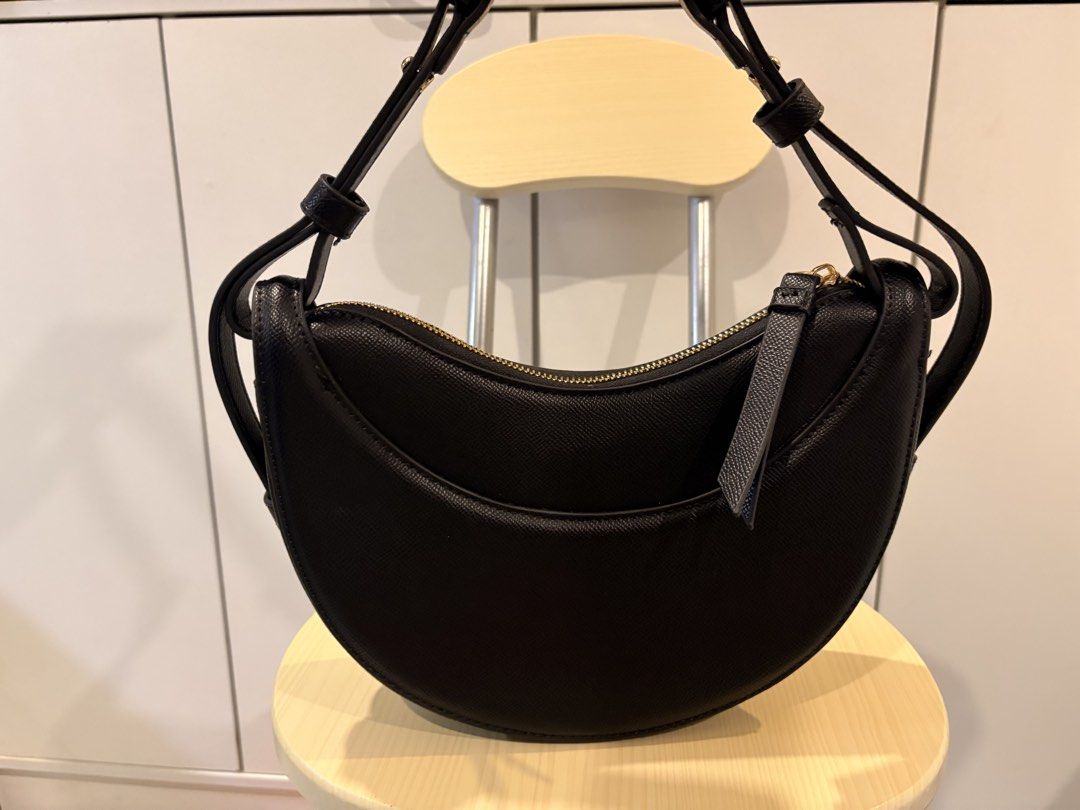 POLENE Black Crescent Shoulder Bag (Category: Luxury Bags & Wallets) located in Manila. Submitted by jonahgmzn (Listing ID 1463226936, Image 2). Description: - Black Polene bag - Stylish crescent shape - Secure zip closure - Convenient front pocket detail - Adjustable strap for comfort - Elegant gold hardware - Ideal for everyday use - Fits all your essentials.