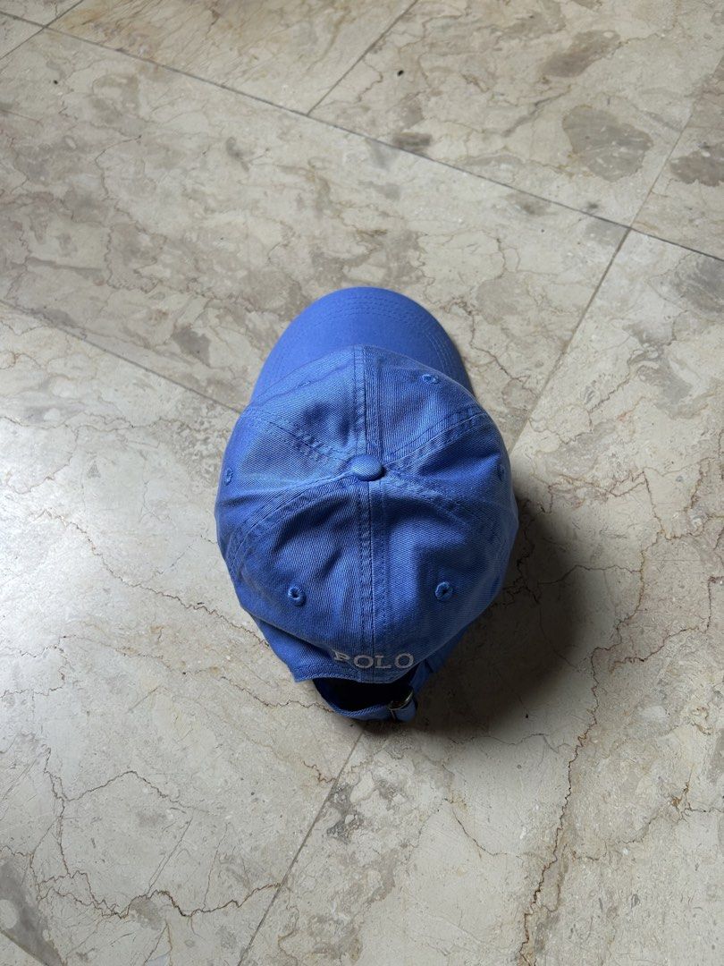 Polo Ralph Lauren Blue Baseball Cap (Category: Caps & Hats) located in Muntinlupa City. Submitted by wavesofara (Listing ID 1463125994, Image 2). Description: - Classic blue baseball cap - Polo Ralph Lauren brand - Iconic polo player logo embroidered on front - 'POLO' text on back strap - Adjustable strap for a comfortable fit - Perfect for everyday wear.