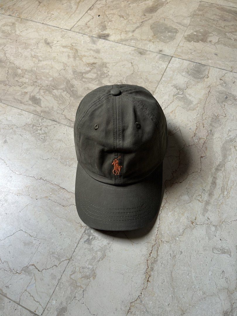 Polo Ralph Lauren Cap Hat Olive Green (Category: Caps & Hats) located in Muntinlupa City. Submitted by wavesofara (Listing ID 1463125973, Image 1). Description: - Authentic Olive Green Polo Ralph Lauren Cap - Iconic Polo Player Logo Embroidery on Front - 'POLO' Text Embroidery on Back - Adjustable Strap for a Custom Fit - Ideal for Everyday Casual Wear.