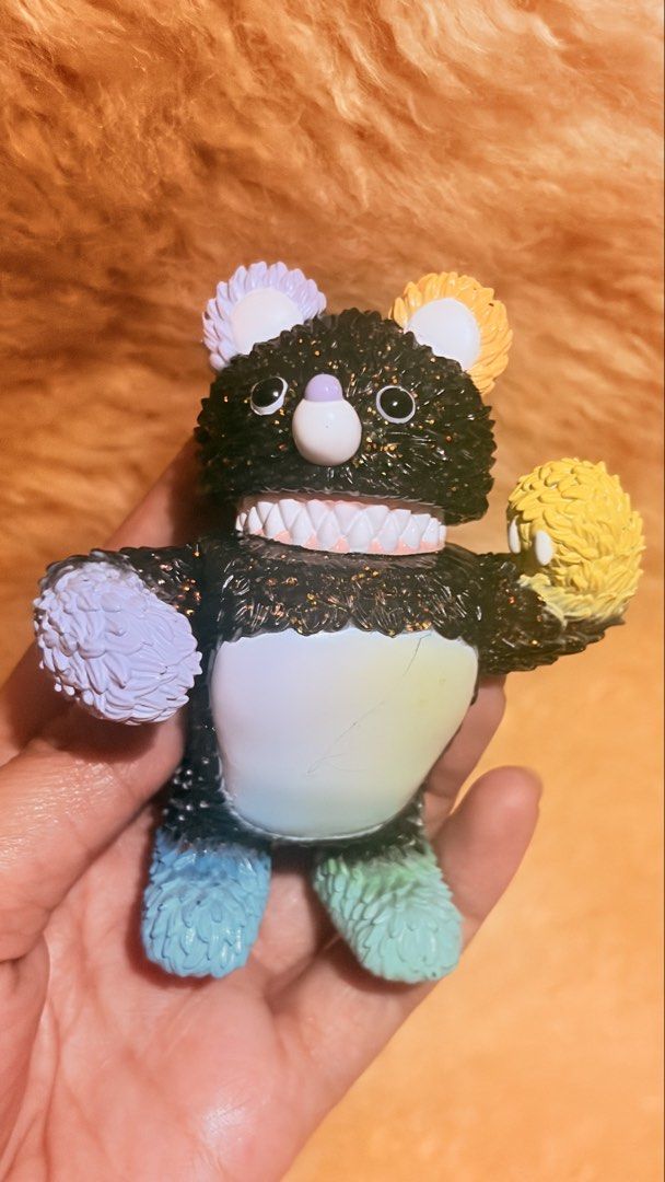POP MART Instinctoy "Molly" Black Glitter Bear Figure (Category: Designer & Blind Box Toys) located in Baguio. Submitted by izza_thrifty (Listing ID 1463249497, Image 2). Description: - Authentic POP MART x Instinctoy collaboration - Striking black glitter finish - Adorable colorful pom-poms on ears and paws - Unique, playful toothy grin - Vibrant rainbow gradient body - Perfect collectible for toy enthusiasts.