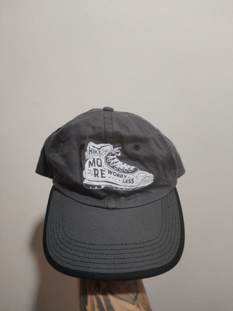 Port Authority Grey Cap OSFA "Hike More Worry Less" (Category: Caps & Hats) located in Naga. Submitted by basejohnpa64527 (Listing ID 1463147007, Image 1). Description: - Brand: Port Authority - Color: Grey - Design: Graphic of a hiking boot with "Hike More Worry Less" text - Size: OSFA (One Size Fits All) - Material: Cotton - Origin: Made in the Philippines.