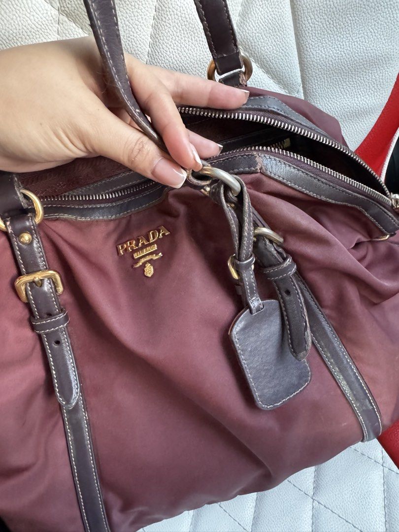 Prada Nylon Tessuto Tote Bag Burgundy (Category: Luxury Bags & Wallets) located in Manila. Submitted by missgrace_collection (Listing ID 1463185751, Image 2). Description: - Authentic Prada bag - Color: Burgundy - Material: Nylon with leather trim - Hardware: Gold - Closure: Top zip - Interior: Spacious - Condition: Handles show some wear - Style: Great everyday bag.