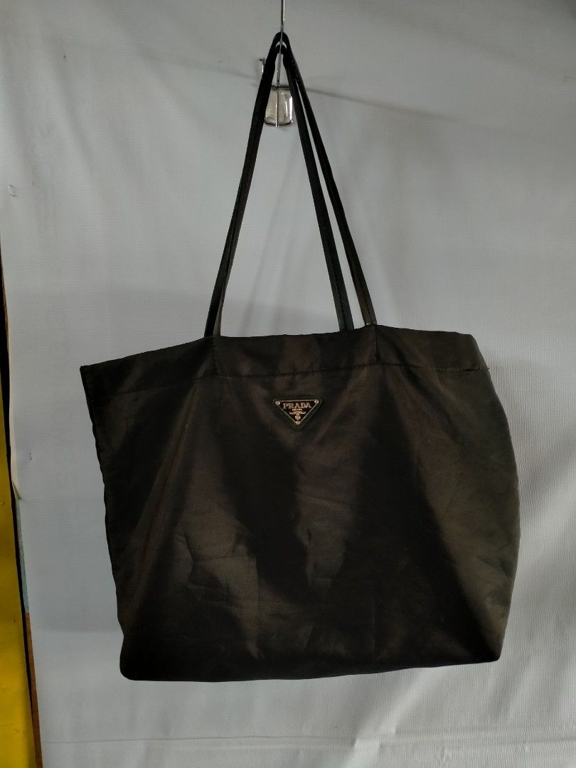 Prada Nylon Tote Bag (Category: Luxury Bags & Wallets) located in Davao. Submitted by ervinpolino09 (Listing ID 1463132062, Image 1). Description: - Classic black Prada tote bag - Durable nylon material - Iconic Prada triangle logo on front - Spacious interior with zippered pocket - Comfortable shoulder straps - Ideal for everyday use or travel.