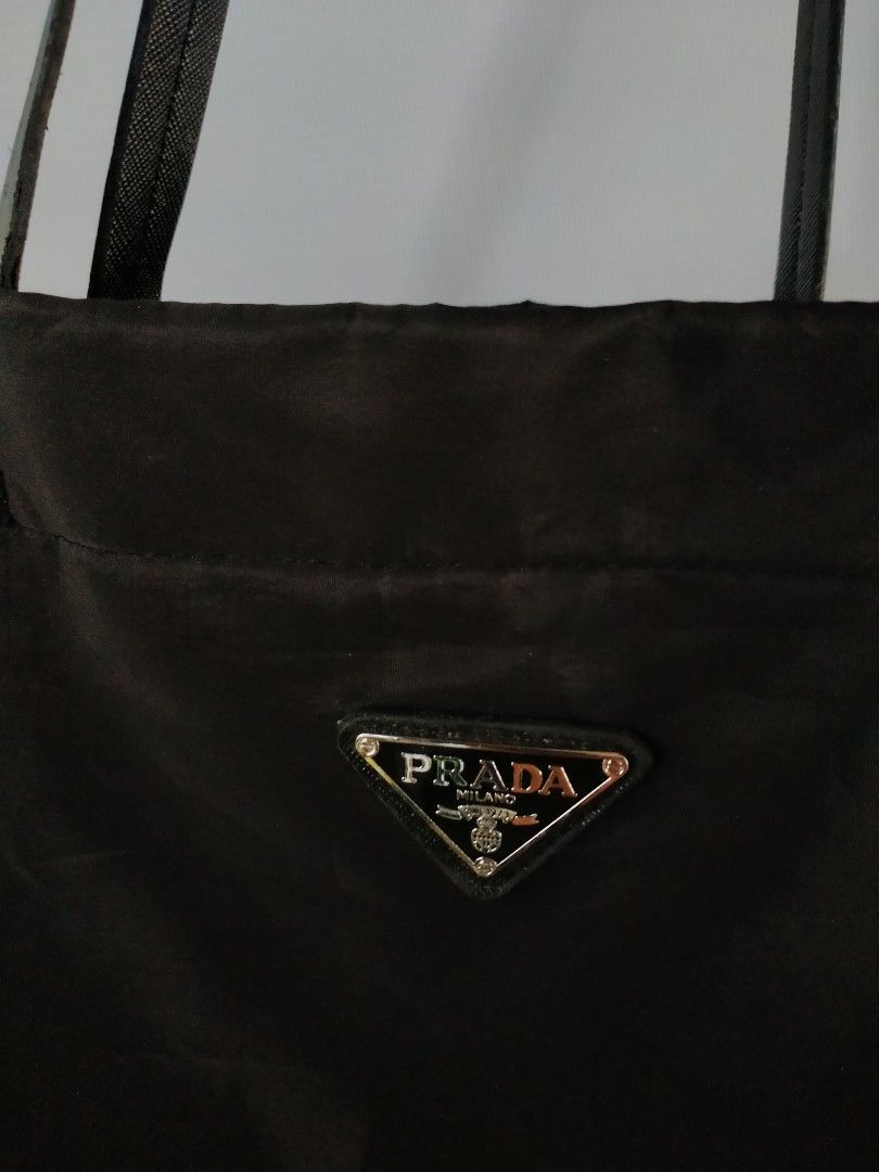 Prada Nylon Tote Bag (Category: Luxury Bags & Wallets) located in Davao. Submitted by ervinpolino09 (Listing ID 1463132062, Image 2). Description: - Classic black Prada tote bag - Durable nylon material - Iconic Prada triangle logo on front - Spacious interior with zippered pocket - Comfortable shoulder straps - Ideal for everyday use or travel.