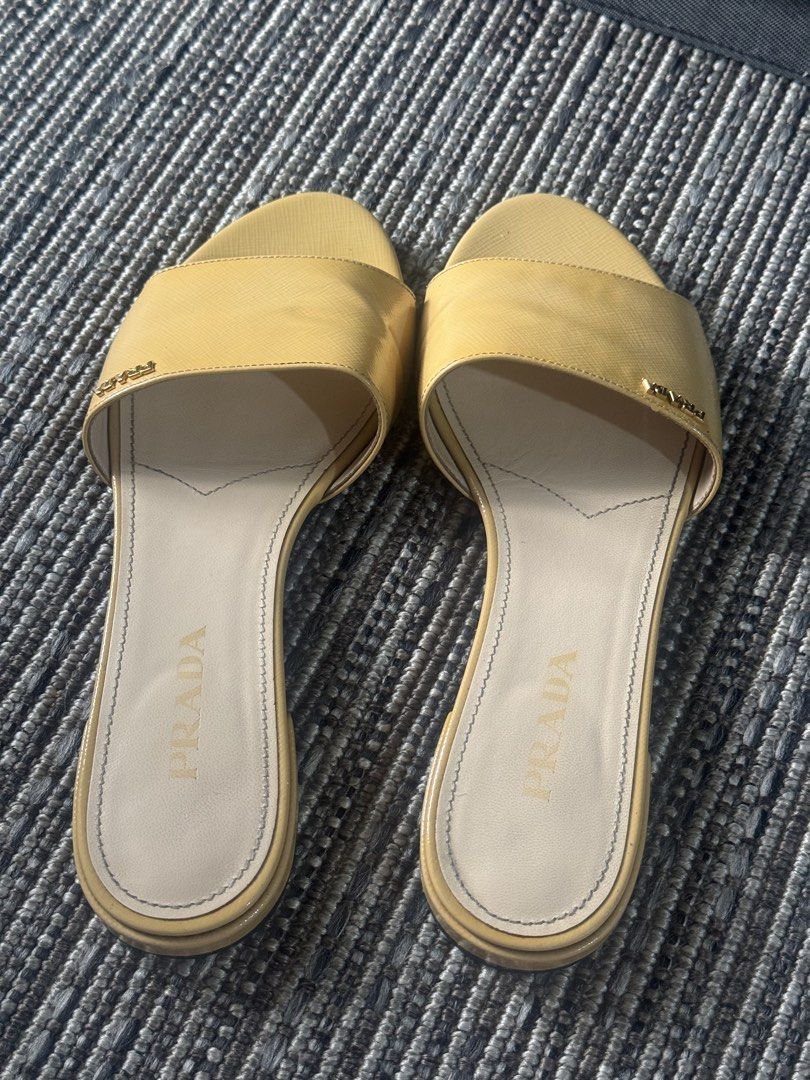Prada Patent Leather Slides Yellow (Category: Sneakers & Footwear) located in Pasig City. Submitted by kclearspace (Listing ID 1463128053, Image 3). Description: Authentic Prada Patent Leather Slides (Yellow) Size: Stamped 38, but fits like a Size 37 (narrow strap). Price Bought: ₱15,000 at Miss Manila Luxe. Upgrades: Upgraded to leather sole + added sole protectors at Mr. Quickie (spent ₱2,000). Inclusions: Original box, dustbag, and card includ