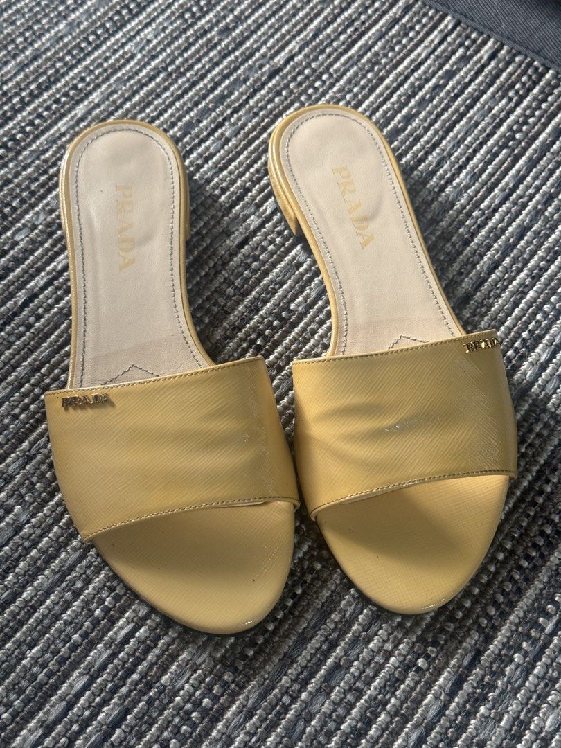 Prada Patent Leather Slides Yellow (Category: Sneakers & Footwear) located in Pasig City. Submitted by kclearspace (Listing ID 1463128053, Image 1). Description: Authentic Prada Patent Leather Slides (Yellow) Size: Stamped 38, but fits like a Size 37 (narrow strap). Price Bought: ₱15,000 at Miss Manila Luxe. Upgrades: Upgraded to leather sole + added sole protectors at Mr. Quickie (spent ₱2,000). Inclusions: Original box, dustbag, and card includ