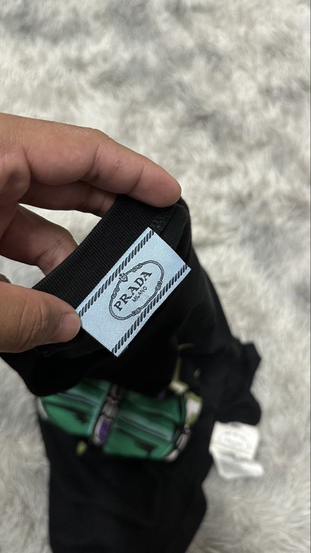 Pr*da tee (Category: Tshirts & Polo Shirts ) located in Manila. Submitted by paulovenegaskalakal2020 (Listing ID 1463153076, Image 2). Description: For sale! Kalakal Pr*da tee Off- good for psg Small- 19 width x 27 length inches Good as new Crispy MINE 1,295 +sg.