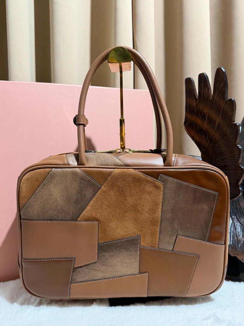 Preloved Leather Patchwork Beau (Category: Luxury Bags & Wallets) located in Manila. Submitted by bagsandmanymanymore1 (Listing ID 1463247101, Image 2). Description: Preloved Miumiu Patchwork Beau Bag Lambskin leather Size 34cm(L) x 23cm(H) x 10cm(W) Leather handle Gold-toned hardware Zipper closure RiRi zipper Patchwork workmanship .