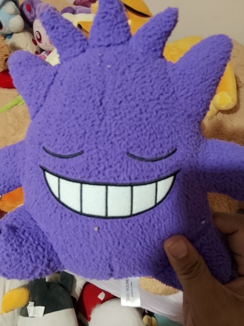 Purple Gengar Pokemon Plush Toy (Category: Plushies & Soft Toys) located in Angeles City. Submitted by yourtrovejapansurplus (Listing ID 1463252036, Image 1). Description: - Adorable purple Gengar plush toy - Features a cute sleeping expression with a big smile - Made from soft and cuddly material - Ideal for any Pokemon fan - Great for both display and playtime - A fun addition to any collection.