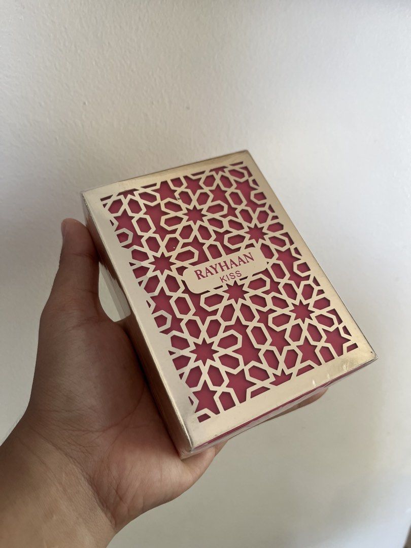 Rayhaan Kiss Perfume (Category: Fragrance & Deodorants) located in Bacolod City. Submitted by vintage_vogue6100 (Listing ID 1463210123, Image 2). Description: - Elegant 'Rayhaan Kiss' perfume box - Features a stylish geometric cut-out design - Luxurious pink interior - Brand name clearly visible - Comes sealed - Ideal as a gift or decorative item.