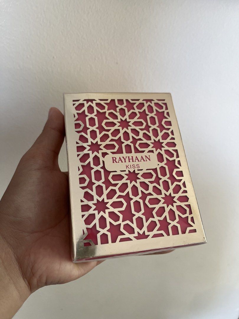 Rayhaan Kiss Perfume (Category: Fragrance & Deodorants) located in Bacolod City. Submitted by vintage_vogue6100 (Listing ID 1463210123, Image 1). Description: - Elegant 'Rayhaan Kiss' perfume box - Features a stylish geometric cut-out design - Luxurious pink interior - Brand name clearly visible - Comes sealed - Ideal as a gift or decorative item.