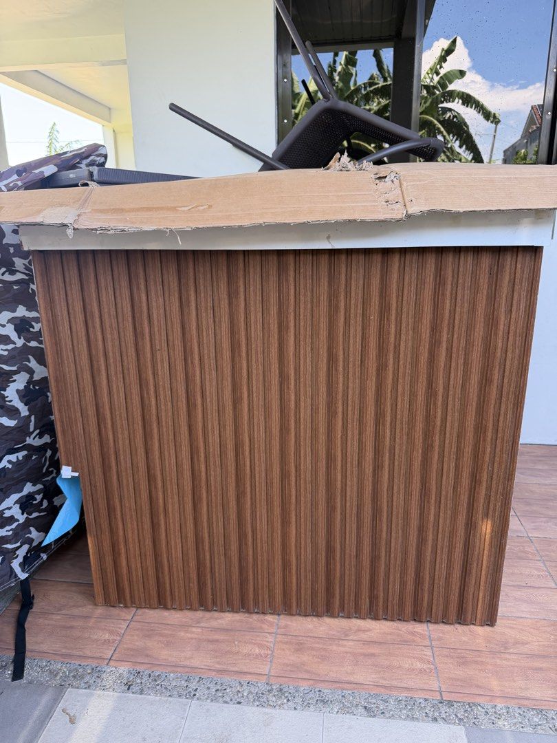Reception counter (Category: Shelves, Cabinets & Racks) located in Manila. Submitted by troddetrading (Listing ID 1463159656, Image 1). Description: - Stylish brown counter with a unique vertical ribbed wood-grain finish. - Versatile use: can function as a storage unit or a small counter. - Ideal for organizing various items and decluttering your space. - Features cardboard packaging on the top edge, indicating it might be new or recently assembl