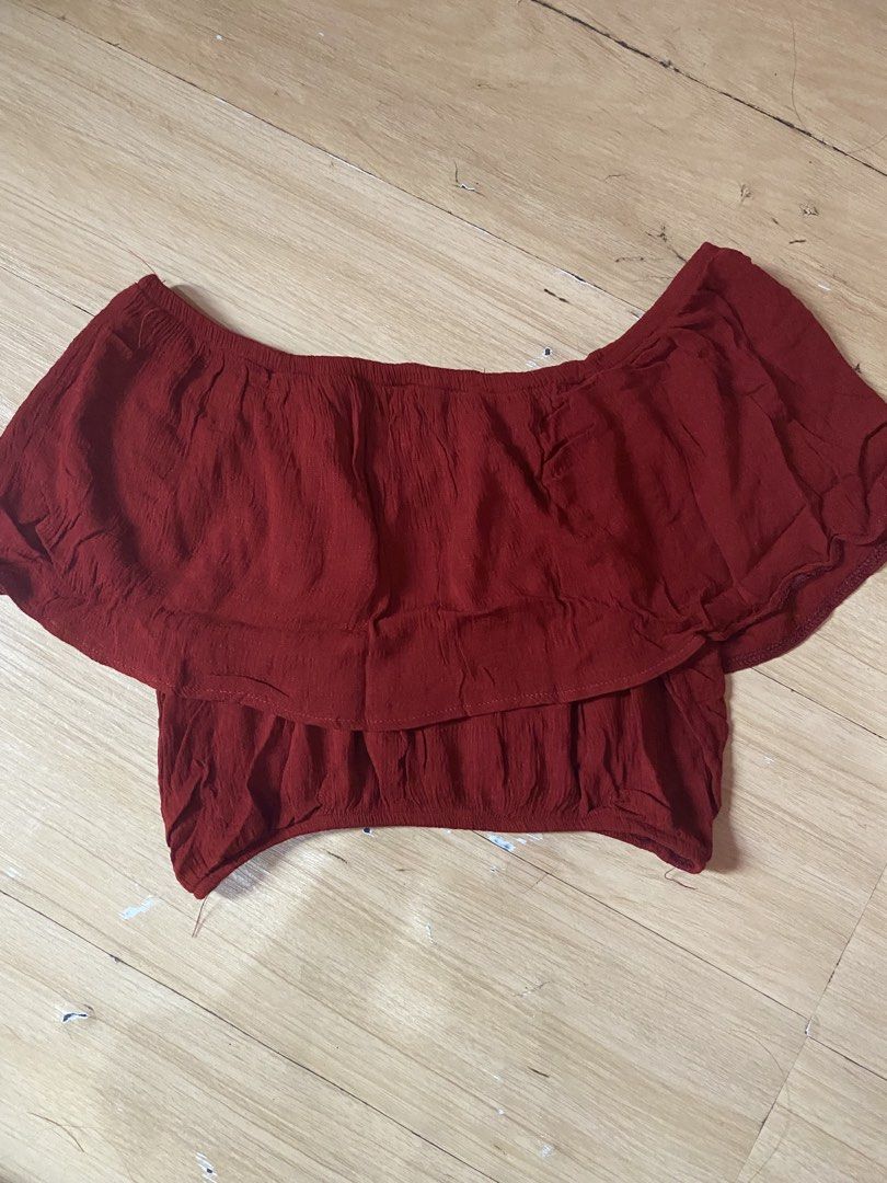 Red Off-Shoulder Ruffle Crop Top (Category: Others Tops) located in Tanauan. Submitted by rie098 (Listing ID 1463275261, Image 2). Description: - Cute red off-shoulder crop top - Features a ruffled overlay - Gathered hem detail - Crinkled fabric texture - Versatile for pairing with high-waisted shorts or jeans - Ideal for casual outings.