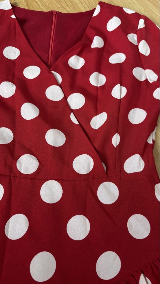 Red Polka Dot Ruffle Wrap Dress (Category: Dresses) located in Cainta. Submitted by prelovebytish (Listing ID 1463159944, Image 3). Description: - Adorable red dress with classic white polka dots. - Flattering wrap style with a chic V-neck. - Fun ruffle details on the skirt for a playful touch. - Versatile three-quarter sleeves. - Ideal for parties, gatherings, or a stylish casual day out. - Combines comfort with a fashionable look..