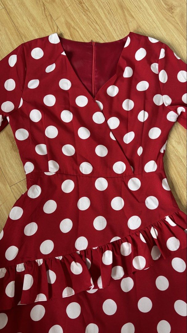 Red Polka Dot Ruffle Wrap Dress (Category: Dresses) located in Cainta. Submitted by prelovebytish (Listing ID 1463159944, Image 2). Description: - Adorable red dress with classic white polka dots. - Flattering wrap style with a chic V-neck. - Fun ruffle details on the skirt for a playful touch. - Versatile three-quarter sleeves. - Ideal for parties, gatherings, or a stylish casual day out. - Combines comfort with a fashionable look..