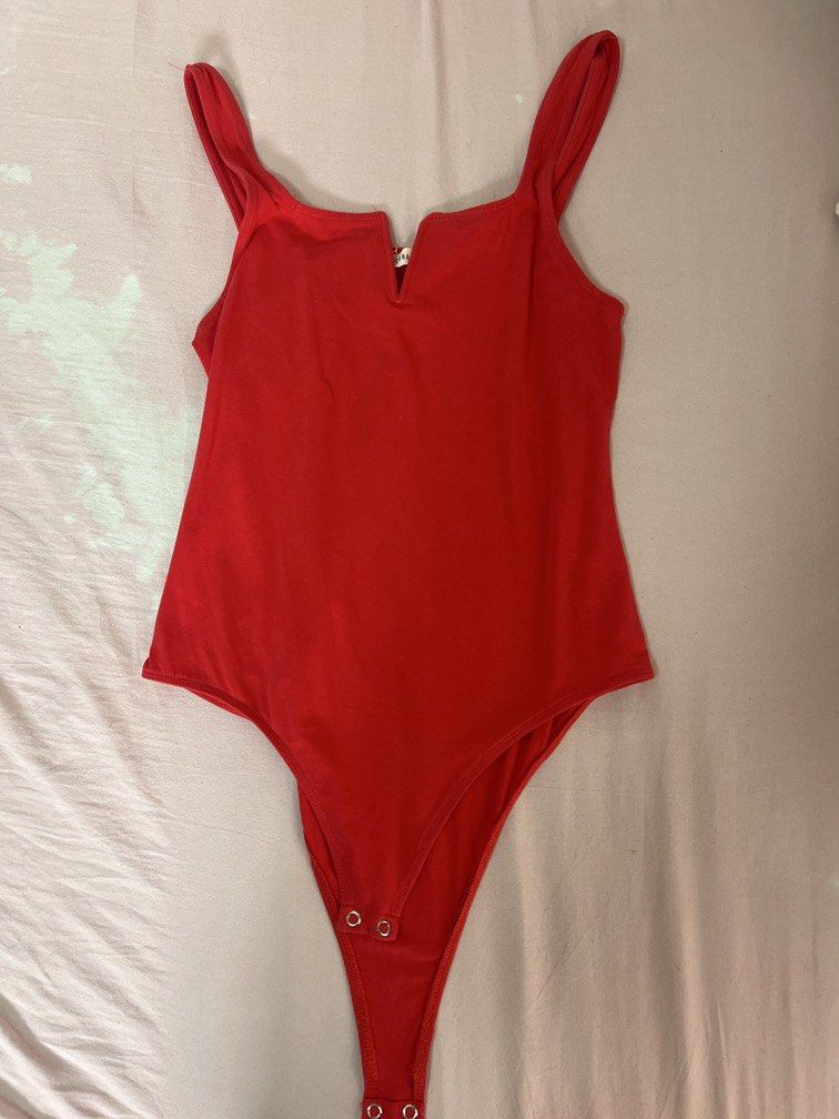 Red V-Neck Bodysuit with Snap Closure (Category: Others Tops) located in Manila. Submitted by elkho (Listing ID 1463282096, Image 1). Description: - Vibrant bright red color - Flattering V-neckline with a chic cutout - Comfortable tank style straps - Thong bottom with convenient snap closure - Stretchy material for a great fit - Versatile piece: perfect for layering or as a standalone top.