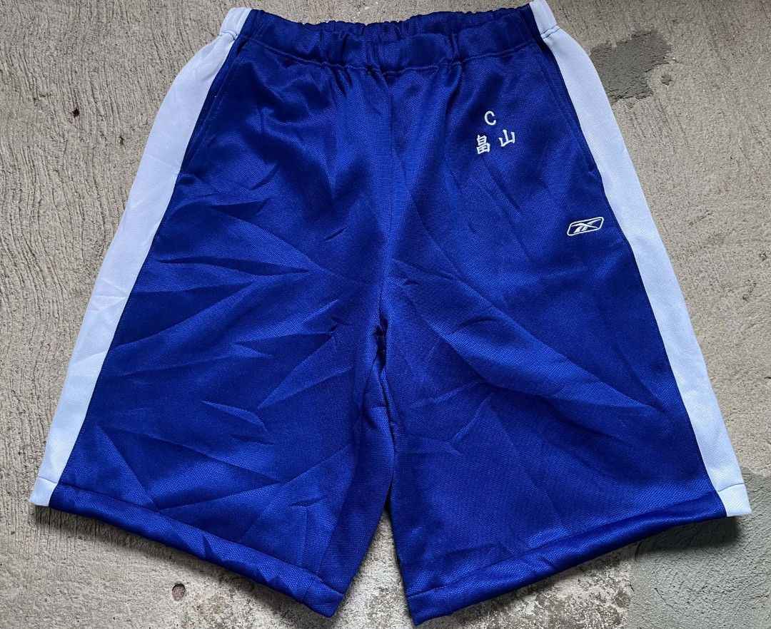 Reebok Blue Athletic Shorts with White Stripes (Category: Shorts) located in Vallehermoso. Submitted by threy (Listing ID 1463203601, Image 2). Description: - Reebok blue athletic shorts - White stripes on the sides - Embroidered Japanese characters on left hip - Comfortable elastic waistband - Ideal for sports and casual wear.