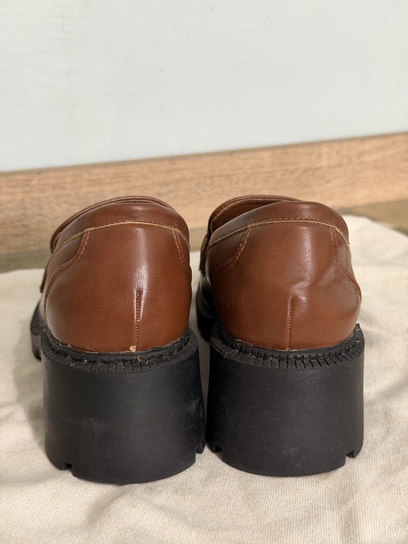 Rock&Rose Brown Loafers (Category: Loafers) located in Magarao. Submitted by coleeloves_ (Listing ID 1463141682, Image 3). Description: - Stylish brown leather loafers - Size 38 - Chunky black sole for comfort and trend - Elegant gold chain detail across the vamp - Modern square toe design - Ideal for everyday wear - Minor scuffs present, as pictured.