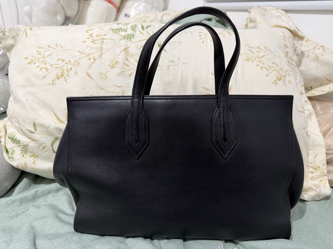 Saint Laurent Black Leather Tote Bag (Category: Luxury Bags & Wallets) located in Manila. Submitted by ney14 (Listing ID 1463217296, Image 2). Description: - Authentic Saint Laurent black leather tote bag - Features a chic tassel detail - Embossed Saint Laurent brand name on the front - Made from soft and supple leather - Comes with original dust bag - Ideal for everyday use or travel -comes with care card and authentication card -with tassel, du