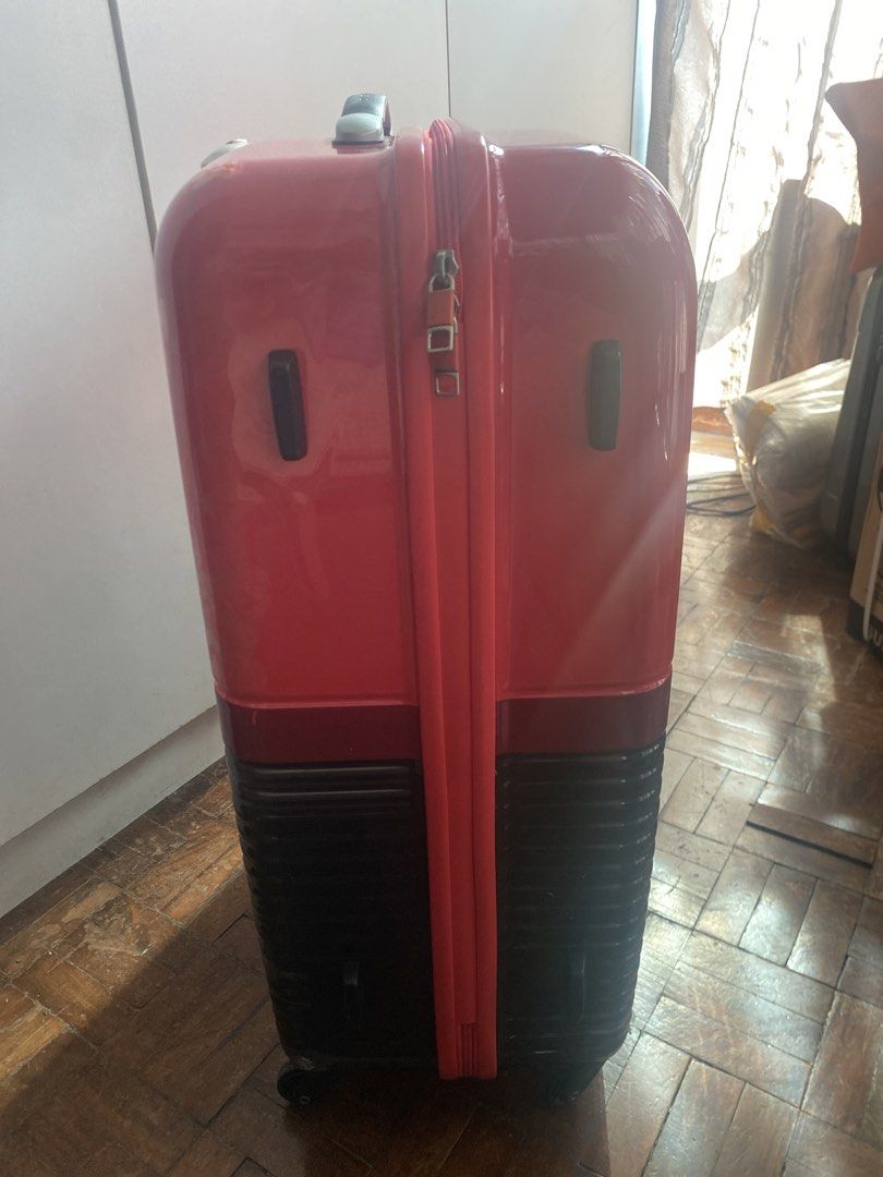 Samsonite RED Red Hardshell Luggage (Category: Luggage) located in Pasig City. Submitted by angelaaaj (Listing ID 1463178294, Image 2). Description: - Samsonite RED hardshell suitcase - Features TSA lock - Wheels are intact and functional - Shows surface scuffs from normal use - Ample interior space for packing.