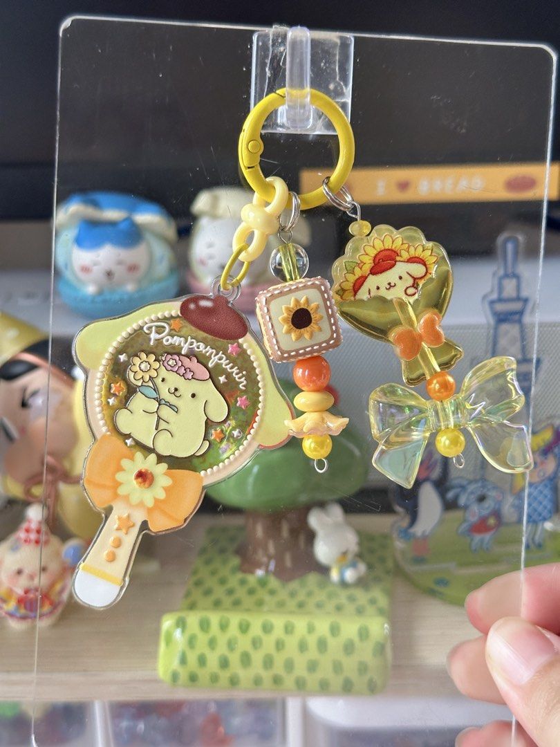Sanrio Pompompurin sunflower bag charm (Category: Character Goods) located in Cainta. Submitted by pomocha (Listing ID 1463260735, Image 1). Description: 🍀Please read before ordering🍀 🍎When being delivered to you they will be packed with care with proper packaging (plastic and paper backing) for your charm 🫶 🍎There is usually no duplicates of each charm, so don’t hesitate because i will most likely never stock this design again, or at least 