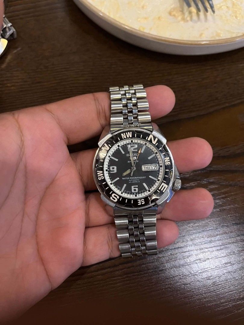 Seiko 5 Automatic Watch 100m Water Resist (Category: Luxury Watches) located in Cebu City. Submitted by jbok_watches. (Listing ID 1463260223, Image 2). Description: - Seiko 5 Automatic Watch - Classic black dial with day and date display - Water resistant up to 100 meters - Durable stainless steel bracelet with fold-over clasp - Rotating bezel featuring compass markings - Shows minor signs of wear on case and bracelet, but functions perfectly..