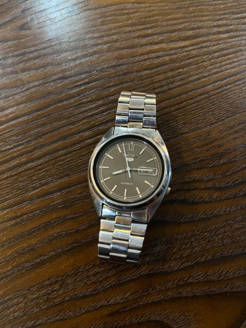 Seiko 5 Automatic Watch (Category: Men's Watches) located in Cebu City. Submitted by jbok_watches. (Listing ID 1463260755, Image 1). Description: - Classic Seiko 5 Automatic Watch - Stainless steel band and case - Day and Date display - Dark grey dial - Good working condition, ready for a new owner.