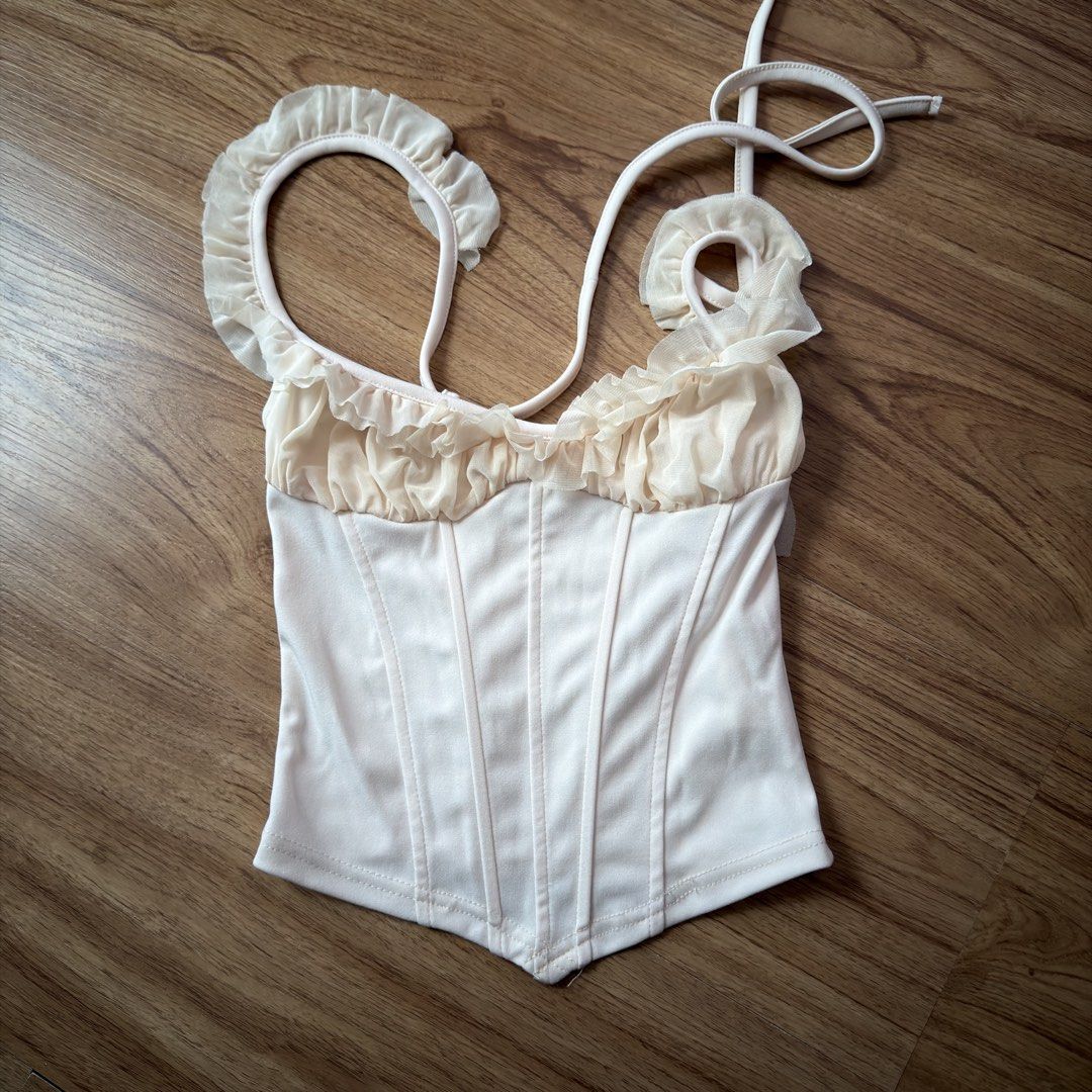 Sheer Ruffle Corset Top - Black & Cream (Category: Sleeveless) located in Paranaque City. Submitted by jlfc_onlineshop (Listing ID 1463188254, Image 1). Description: The price is for the two items already (black and cream) Used once Discount applicable for multiple items No WW photos, No Stains Payment-first basis Bpi/Maya only.