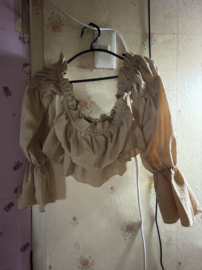 SHEIN Beige Ruffled Square Neck Crop Top (Category: Blouses) located in Marikina City. Submitted by chamscouture (Listing ID 1463140255, Image 1). Description: - Beige crop top from SHEIN - Square neckline with delicate ruffles - Trendy long puff sleeves with ruffled cuffs - Textured fabric for a stylish look - Size S -pm when worn.