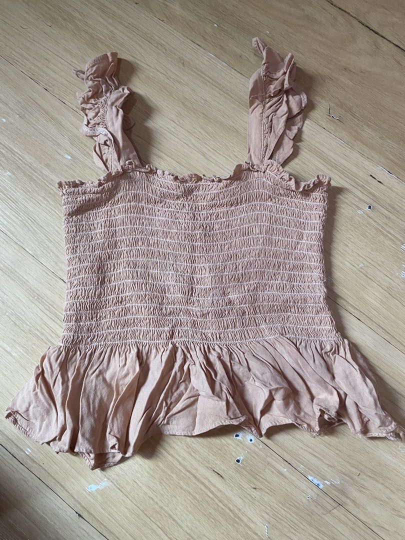 Smocked Ruffle Strap Peplum Top - Nude (Category: Sleeveless) located in Tanauan. Submitted by rie098 (Listing ID 1463277341, Image 1). Description: - Cute nude smocked top - Ruffle straps - Peplum hem for flow - Stretchy smocking all over bodice - Versatile for casual or dressy looks - Easy to pair with jeans or skirts.