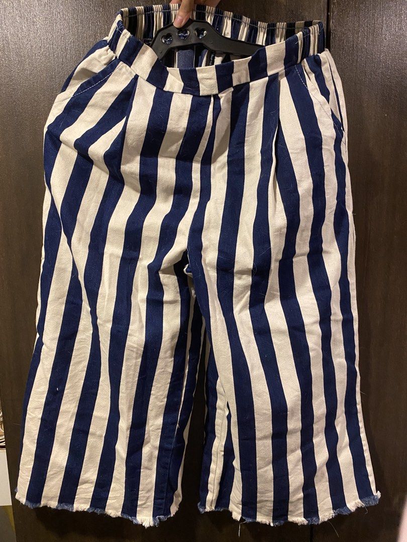Striped Culottes with Elastic Waistband (Category: Other Bottoms) located in Manila. Submitted by hanzlopez (Listing ID 1463272559, Image 1). Description: - Chic navy and white striped culottes - Comfortable elastic waistband - Trendy wide leg with a frayed hem - Convenient side pockets - Ideal for casual outfits - Effortlessly pairs with various tops.
