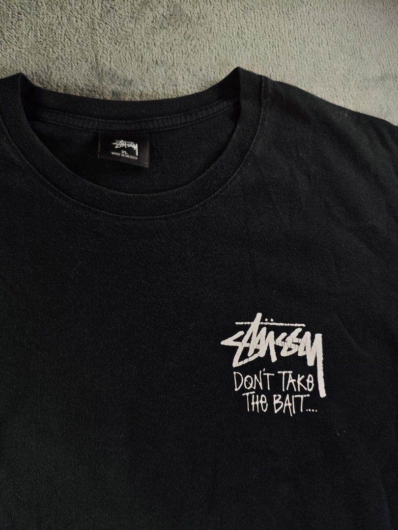 Stussy Don't Take The Bait Black Tee (Category: Tshirts & Polo Shirts ) located in San Pedro. Submitted by chronothrift2ndacc (Listing ID 1463183821, Image 3). Description: - Size: XL (W23 x 29L) - Condition: 8.5/10 - Color Rate: 9/10 - Flaws: Hairline Cracks / Very Minor Pinhole MOD: J&T Express / Lalamove / Meet MOP: Gcash / Bank Transfer.
