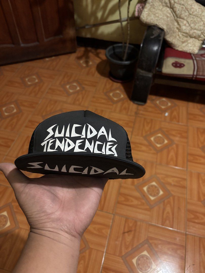 Suicidal Tendencies Black Mesh Trucker Cap (Category: Caps & Hats) located in Polomolok. Submitted by rrthrift (Listing ID 1463236707, Image 1). Description: - Black trucker cap with Suicidal Tendencies logo - Mesh back for breathability - Adjustable snapback closure - "Made in USA" tag inside - Ideal for fans of the band.