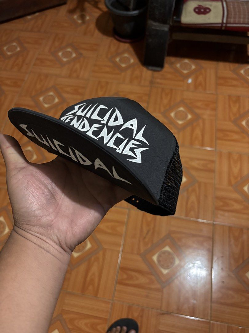 Suicidal Tendencies Black Mesh Trucker Cap (Category: Caps & Hats) located in Polomolok. Submitted by rrthrift (Listing ID 1463236707, Image 2). Description: - Black trucker cap with Suicidal Tendencies logo - Mesh back for breathability - Adjustable snapback closure - "Made in USA" tag inside - Ideal for fans of the band.