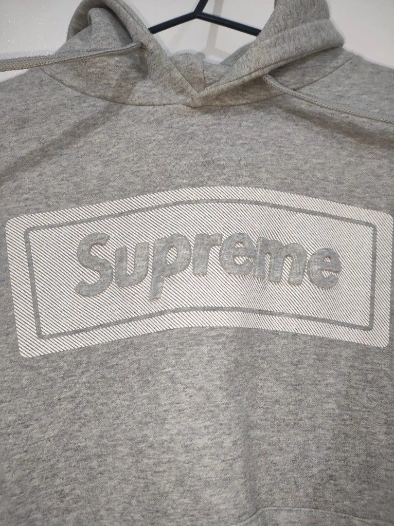 Supreme Grey Hoodie Size L (Category: Hoodies) located in Quezon City. Submitted by maxsab (Listing ID 1463203452, Image 2). Description: - Authentic Grey Supreme Hoodie - Size: Large (L) - Iconic front box logo design - Small red Supreme tag detail on sleeve and hem - Material: 100% Cotton - Origin: Made in Korea.