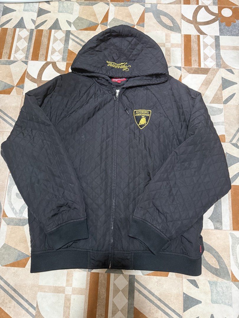 Supreme Lamborghini Quilted Jacket Black (Category: Coats, Jackets and Outerwear) located in Baguio. Submitted by shadaxcel (Listing ID 1463321781, Image 3). Description: - Supreme x Lamborghini collaboration bomber jacket - Color: Black - Quilted design - Full zip closure with hood - Iconic Lamborghini shield logo on back - Smaller Lamborghini logo on chest - Ribbed cuffs and hem - Material: 100% Polyester - Perfect for fans of Supreme and Lambo