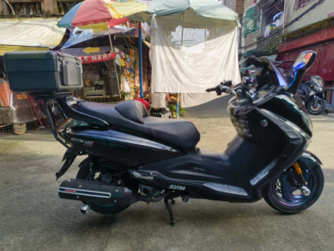 SYM GTS 300i EVO Scooter with Top Box (Category: Motorbikes for Sale) located in Caloocan City. Submitted by sab418 (Listing ID 1463155126, Image 2). Description: SYM GTS 300i EVO COMPLETE ORIGINAL OR CR with PLATE ✅Washable Air filter ✅Windshield DCR Style ✅LED Headlight with High & Low ✅DCR Drag Bar ✅DCR Break Lever ✅Carbon Fiber(some parts) ✅CP Holder Installed ✅Rear Double Contact Signal Light ✅Front and Rear Dash Cam w/ TPMS ✅Pirelli Diablo 