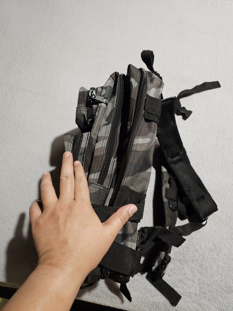 Tactical Camouflage Backpack Bag (Category: Backpacks) located in Makati City. Submitted by richpaul_ (Listing ID 1463305453, Image 3). Description: - Grey camouflage tactical backpack - Multiple pockets and compartments for organization - MOLLE webbing for attaching extra gear - Padded straps for comfortable carrying - Durable material, built to last - Smooth working zippers - Perfect for outdoor adventures or everyday use.