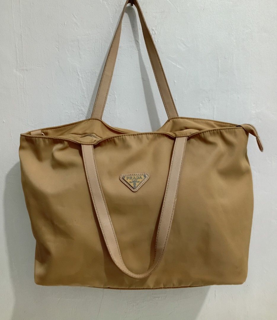 Tan Prad1a Nylon Tote Shoulder Bag (Category: Luxury Bags & Wallets) located in Navotas City. Submitted by ms.soulana (Listing ID 1463275190, Image 3). Description: PreOwned Lightly Used Tan Prada Tote Shoulder Bag Medium -Large Min Sign of Used Clean innerlining - Durable Nylon Material with Leather Trim - Secure Zipper Closure - Spacious Interior - Ideal for Everyday or Travel - Still a functional Flaws :( Staples )Check last Posted Picture reg