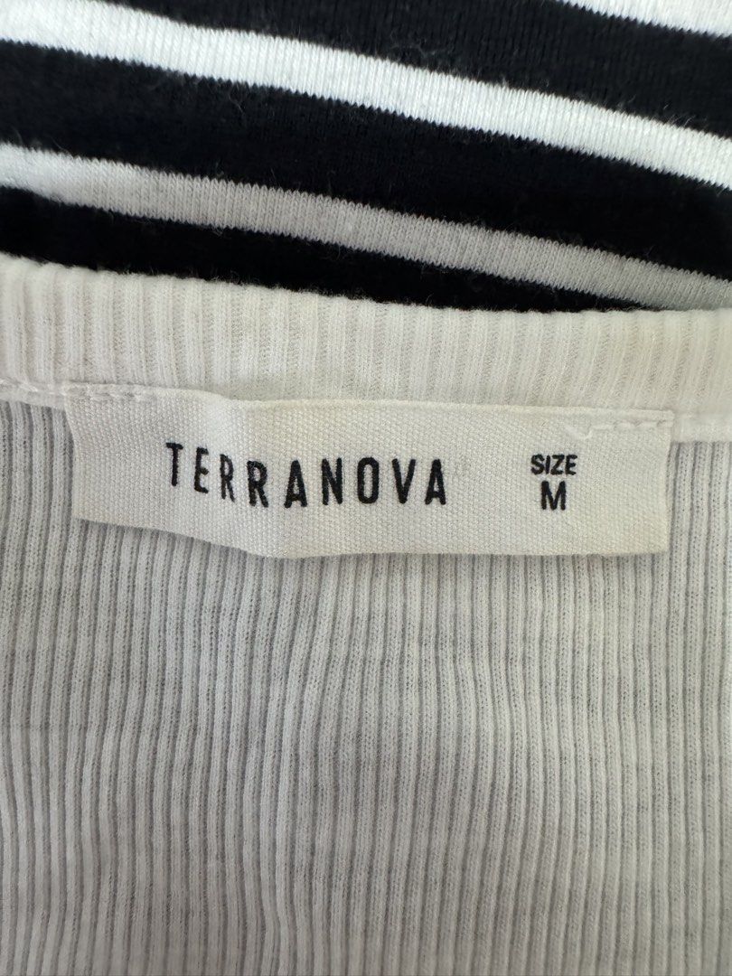 TERRANOVA White Ribbed Button Up Cropped Top Size M (Category: Shirts) located in Manila. Submitted by prelovedshopmnl (Listing ID 1463181292, Image 3). Description: - White ribbed crop top - Brand: Terranova - Short sleeves with lettuce hem detail - Button-up front - Versatile for layering or wearing alone - Size: Medium (M).