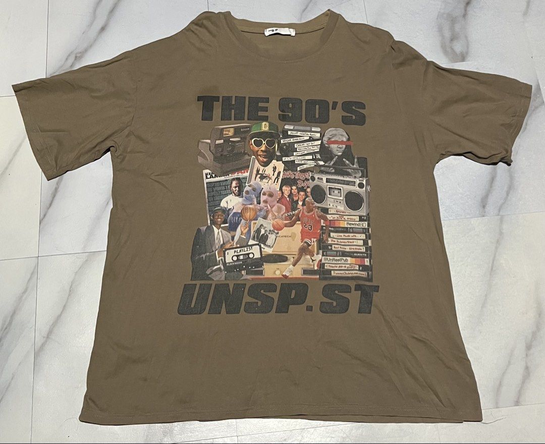 The 90's Graphic T-Shirt (Category: Tshirts & Polo Shirts ) located in Cavite. Submitted by christianzuuu (Listing ID 1463133513, Image 1). Description: - Brown t-shirt with a retro 90s collage graphic. - Features iconic 90s imagery: Michael Jordan, boomboxes, cassette tapes. - Printed text: 'THE 90'S' and 'UNSP.ST' on the front. - Ideal for fans of 90s nostalgia. - Comfortable and relaxed fit..