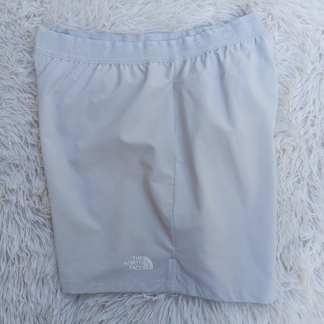 The North Face Shorts Light Grey unisex (Category: Shorts) located in Gattaran. Submitted by thrift_wiseph (Listing ID 1463200522, Image 1). Description: - Brand: The North Face - Color: Light Grey - Features: Elastic waistband with logo detail, side zippered pocket - Ideal for: Workouts, casual wear - Material: Comfortable and lightweight.