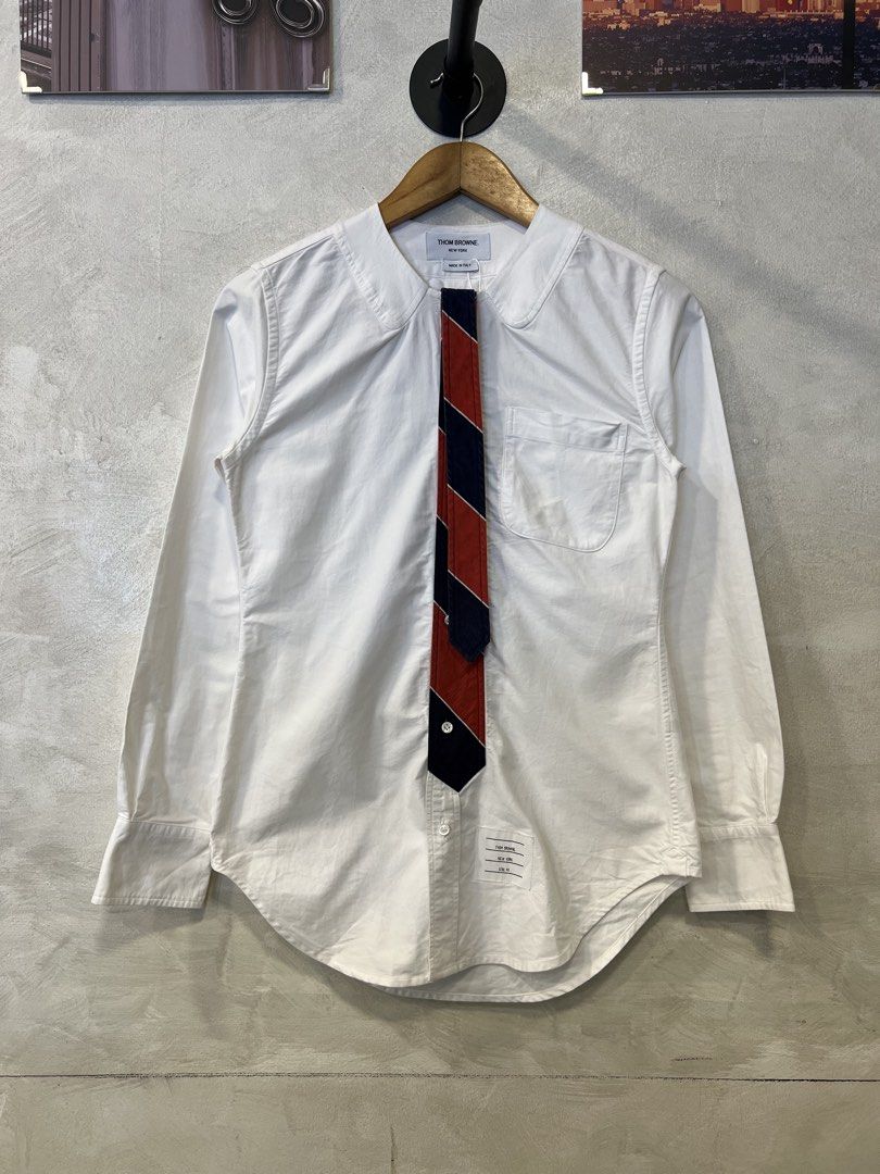 Thom browne Decorative Tie button down shirt (Category: Tshirts & Polo Shirts ) located in Manila. Submitted by -handpick- (Listing ID 1463180618, Image 1). Description: This is a crisp white Thom Browne shirt featuring a distinctive red and navy decorative tie design and a rounded collar. Size : 40 Dimensions : Length : 28 Width : 17 Shoulder : 14.5 Sleeve : 23.5 Sign of wear in good condition (Washable dirt) .