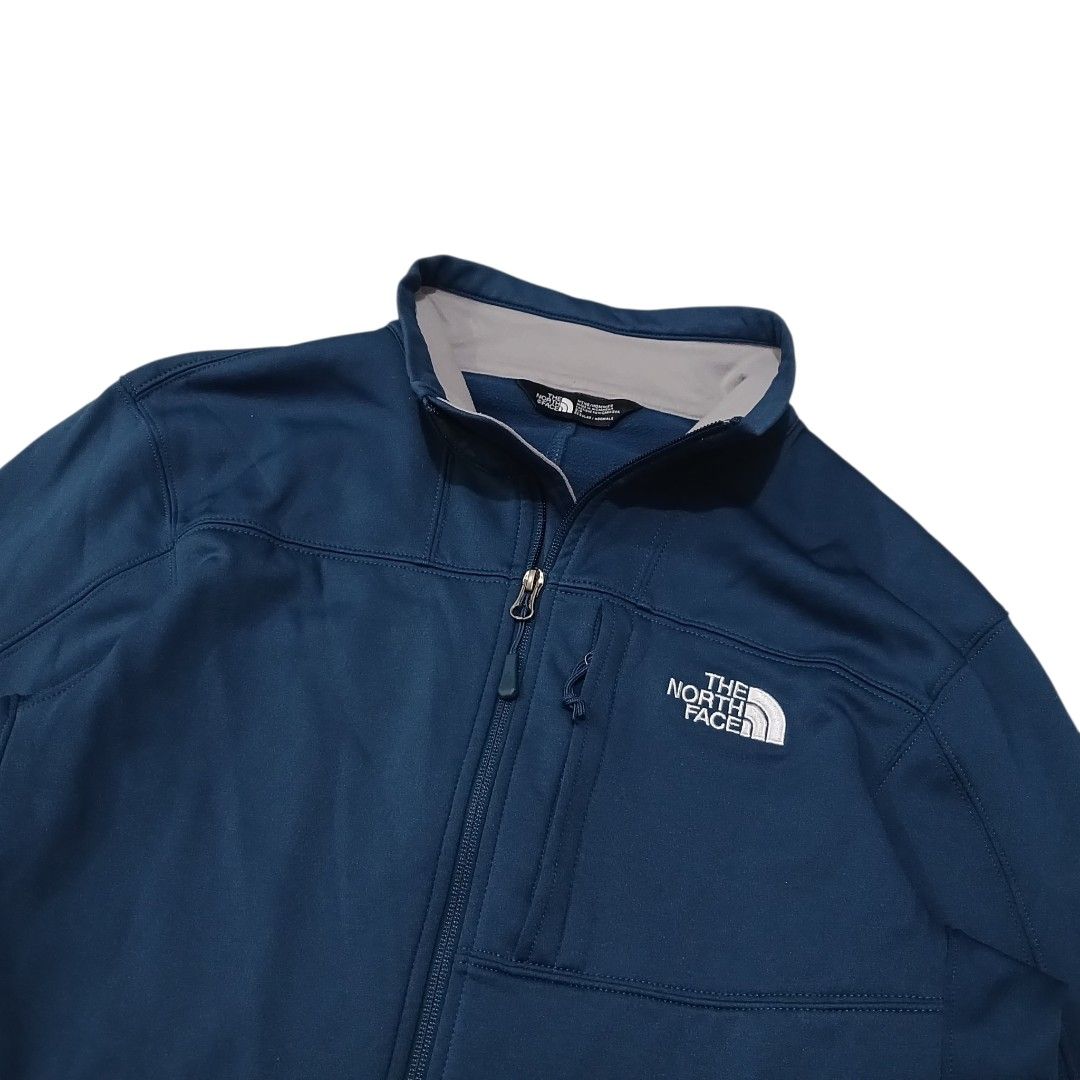 TNF SoftShell Jacket (Category: Coats, Jackets and Outerwear) located in Iloilo. Submitted by wearmovement.ilo (Listing ID 1463262954, Image 2). Description: TNF SoftShell Jacket Navy Blue Color Rate 10/10 Size Medium Men's Dimensions 20.5 Width x 26.5 Length Good as New Condition / Full Zip Three Zipper Pockets / Embroidered Logo Drawcords / Stretchable Fabric DM 📩📩📩.